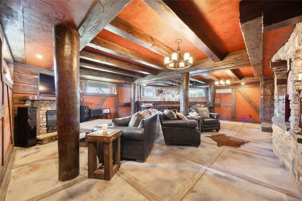 Chandelier, Fireplace, Interior, Living room, Recessed Lighting, Stone Walls, Wooden Beams