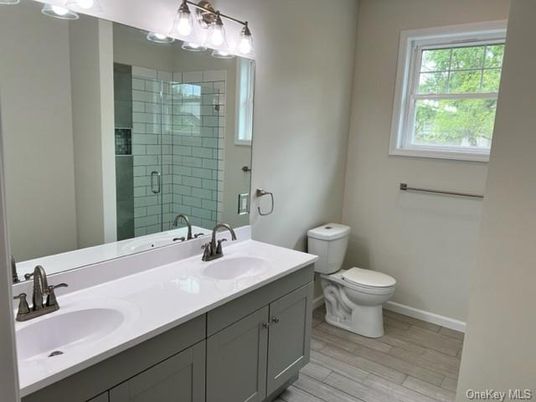 Bathroom, Dual Sink Vanities, Glass Shower, Interior, Wood Texture Flooring