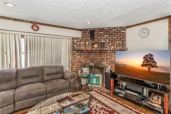 Fireplace, Interior, Living room, Recessed Lighting, Stone Walls, Wood Texture Flooring