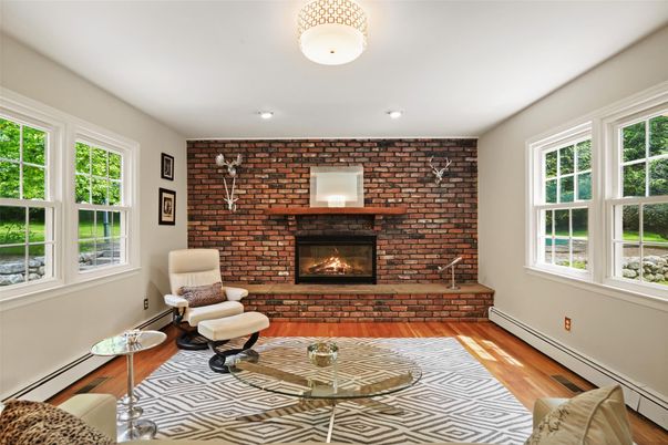Fireplace, Interior, Living room, Recessed Lighting, Stone Walls, Wood Texture Flooring