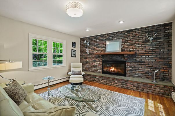 Fireplace, Interior, Living room, Recessed Lighting, Stone Walls, Wood Texture Flooring