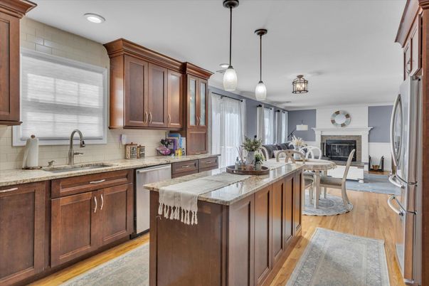Dining room, Fireplace, Interior, Kitchen, Pendant Lights, Recessed Lighting, Stainless Steel Appliances, Wood Texture Flooring