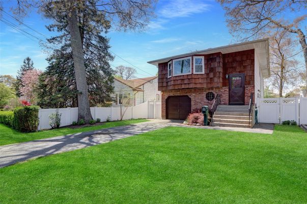 Attached, Backyard, Exterior, Facade, Brick Facade, Raised Ranch