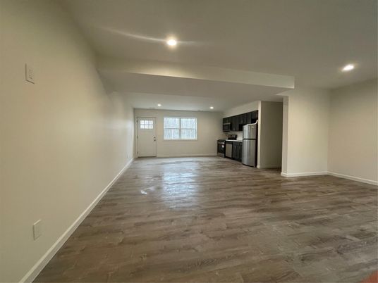 Empty room, Interior, Kitchen, Recessed Lighting, Stainless Steel Appliances, Wood Texture Flooring