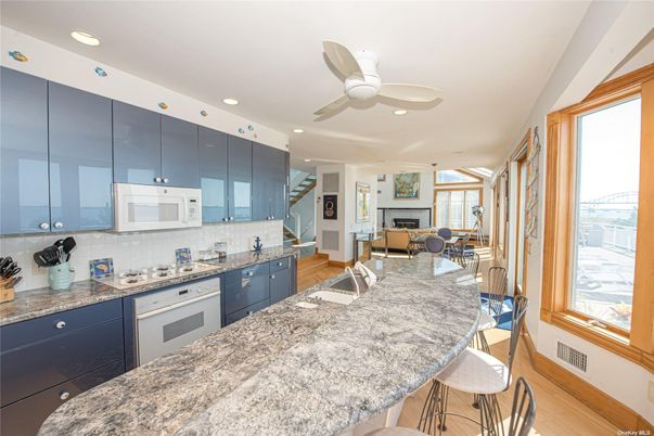 Dining room, Fireplace, Interior, Kitchen, Recessed Lighting, Wood Texture Flooring