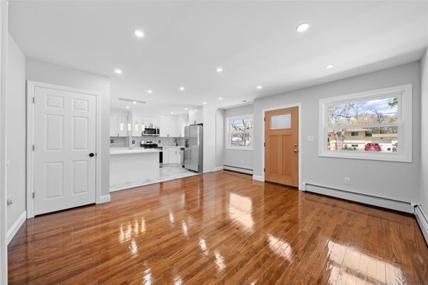 Empty room, Interior, Kitchen, Recessed Lighting, Stainless Steel Appliances, Wood Texture Flooring