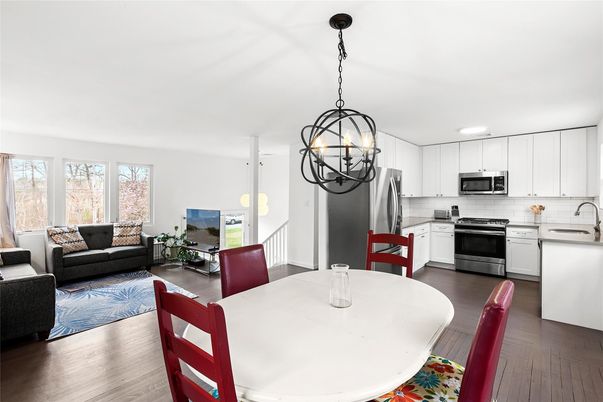 Chandelier, Dining room, Interior, Kitchen, Living room, Pendant Lights, Recessed Lighting, Stainless Steel Appliances, Wood Texture Flooring