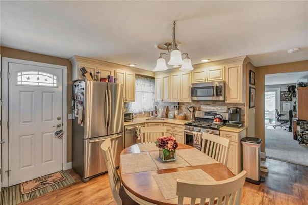 Dining room, Interior, Kitchen, Pendant Lights, Recessed Lighting, Stainless Steel Appliances, Wood Texture Flooring