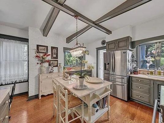 Chandelier, Dining room, Interior, Kitchen, Pendant Lights, Stainless Steel Appliances, Stone Walls, Wooden Beams, Wood Texture Flooring