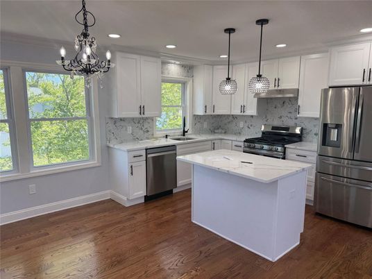 Chandelier, Interior, Kitchen, Marble Walls, Pendant Lights, Recessed Lighting, Stainless Steel Appliances, Wood Texture Flooring