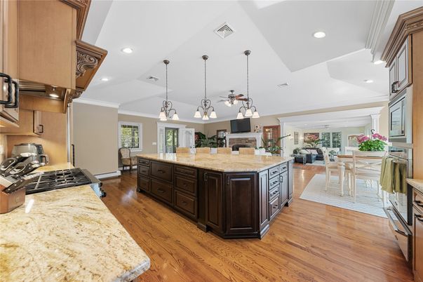 Chandelier, Dining room, Interior, Kitchen, Living room, Pendant Lights, Recessed Lighting, Stainless Steel Appliances, Wood Texture Flooring
