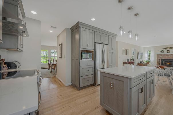 Dining room, Fireplace, Interior, Kitchen, Pendant Lights, Recessed Lighting, Stainless Steel Appliances, Wood Texture Flooring