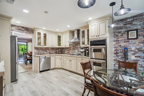 Dining room, Interior, Kitchen, Pendant Lights, Recessed Lighting, Stainless Steel Appliances, Stone Walls, Wood Texture Flooring