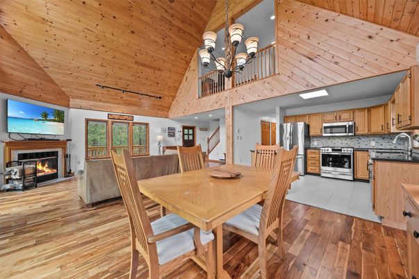 Chandelier, Dining room, Fireplace, Interior, Kitchen, Stainless Steel Appliances, Wooden Ceilings, Wood Texture Flooring