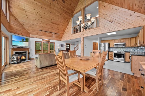 Chandelier, Dining room, Fireplace, Interior, Kitchen, Recessed Lighting, Stainless Steel Appliances, Wooden Beams, Wooden Ceilings, Wood Texture Flooring