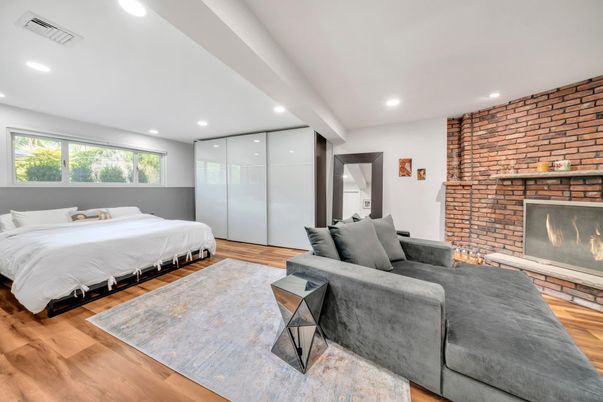 Bedroom, Fireplace, Interior, Recessed Lighting, Stone Walls, Wood Texture Flooring