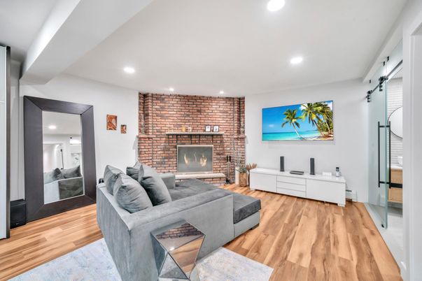 Fireplace, Interior, Living room, Recessed Lighting, Stone Walls, Wood Texture Flooring