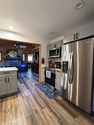 Fireplace, Interior, Kitchen, Recessed Lighting, Stainless Steel Appliances, Stone Walls, Wood Texture Flooring