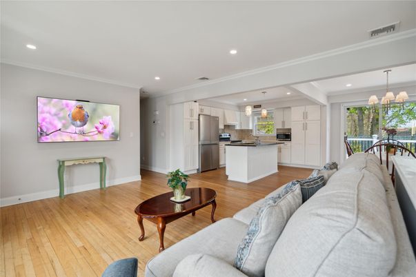 Chandelier, Dining room, Interior, Kitchen, Living room, Pendant Lights, Recessed Lighting, Stainless Steel Appliances, Wood Texture Flooring