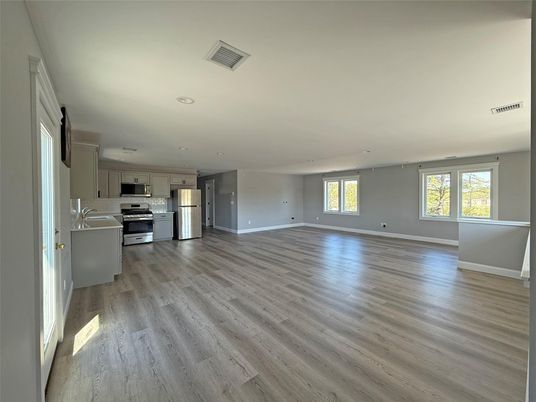 Empty room, Interior, Kitchen, Recessed Lighting, Stainless Steel Appliances, Wood Texture Flooring