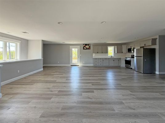 Empty room, Interior, Kitchen, Recessed Lighting, Stainless Steel Appliances, Wood Texture Flooring