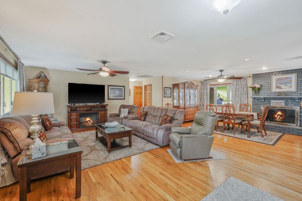 Dining room, Fireplace, Interior, Living room, Recessed Lighting, Stone Walls, Wood Texture Flooring