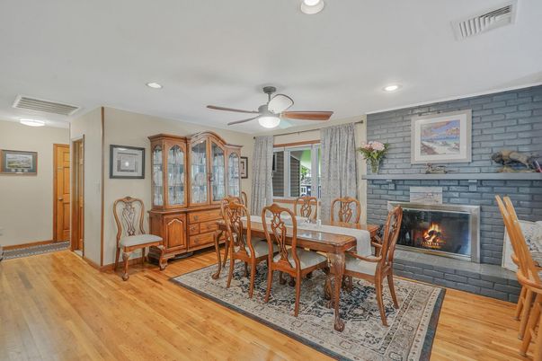 Dining room, Fireplace, Interior, Recessed Lighting, Stone Walls, Wood Texture Flooring