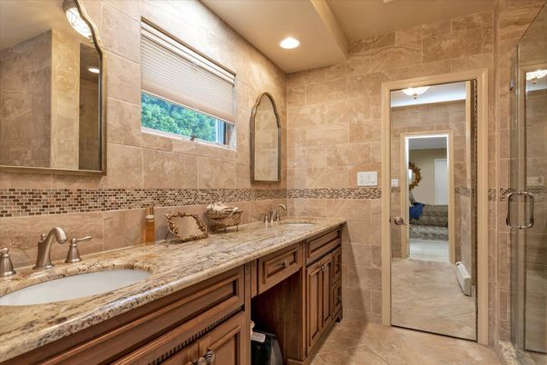 Bathroom, Dual Sink Vanities, Glass Shower, Interior, Recessed Lighting, Stone Walls