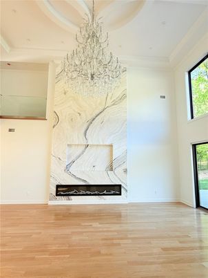 Chandelier, Empty room, Fireplace, Interior, Marble Walls, Recessed Lighting, Wood Texture Flooring