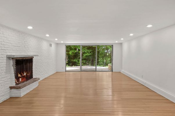 Empty room, Fireplace, Interior, Recessed Lighting, Stone Walls, Wood Texture Flooring
