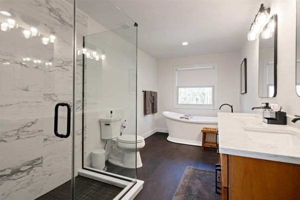 Bathroom, Dual Sink Vanities, Free Standing Baths, Glass Shower, Interior, Marble Walls, Recessed Lighting, Wood Texture Flooring