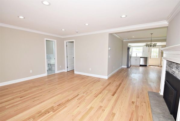 Empty room, Fireplace, Interior, Kitchen, Pendant Lights, Recessed Lighting, Stainless Steel Appliances, Wood Texture Flooring
