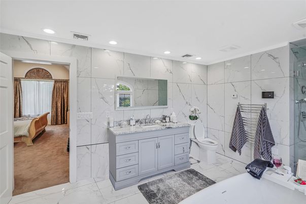 Bathroom, Dual Sink Vanities, Glass Shower, Interior, Marble, Marble Walls, Recessed Lighting