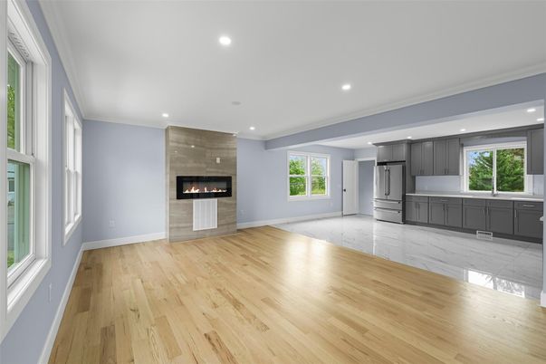 Empty room, Fireplace, Interior, Kitchen, Marble, Recessed Lighting, Stainless Steel Appliances, Wood Texture Flooring