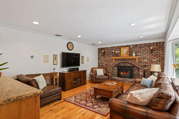 Fireplace, Interior, Living room, Recessed Lighting, Stone Walls, Wood Texture Flooring