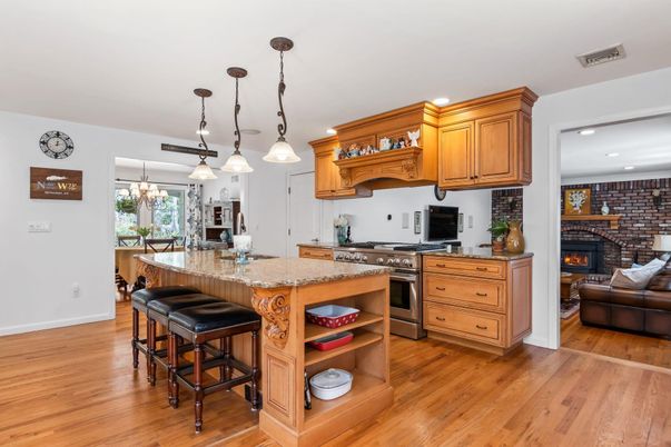 Fireplace, Interior, Kitchen, Living room, Pendant Lights, Recessed Lighting, Stainless Steel Appliances, Stone Walls, Wood Texture Flooring