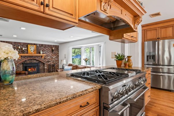 Fireplace, Interior, Kitchen, Recessed Lighting, Stainless Steel Appliances, Stone Walls, Wood Texture Flooring