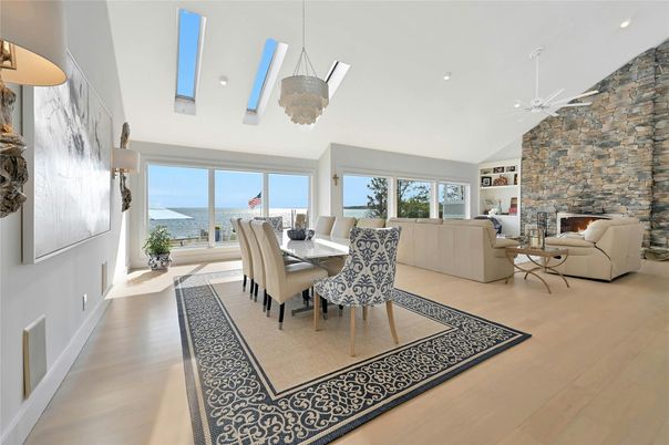 Dining room, Fireplace, Interior, Living room, Pendant Lights, Recessed Lighting, Stone Walls, Water, Wood Texture Flooring