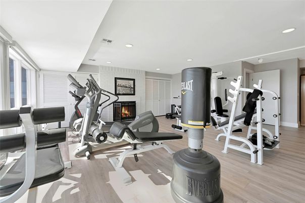 Fireplace, Fitness Equipment, Gym, Interior, Recessed Lighting, Wood Texture Flooring