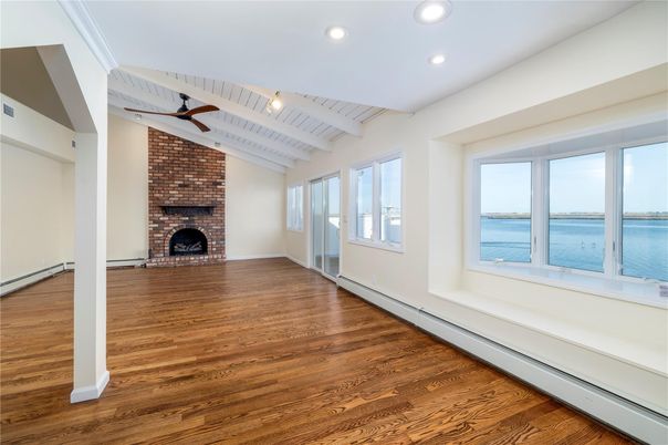 Empty room, Fireplace, Interior, Recessed Lighting, Stone Walls, Water, Wood Texture Flooring