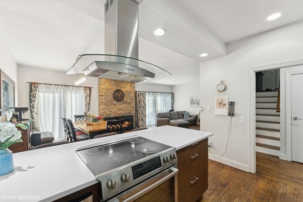 Dining room, Fireplace, Interior, Kitchen, Living room, Pendant Lights, Recessed Lighting, Stainless Steel Appliances, Stone Walls, Wood Texture Flooring