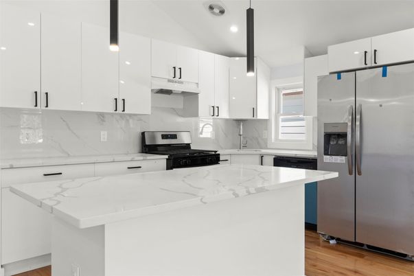 Interior, Kitchen, Marble Walls, Recessed Lighting, Stainless Steel Appliances, Wood Texture Flooring