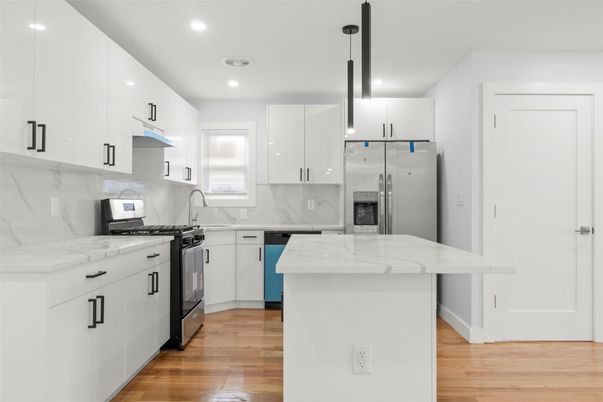 Interior, Kitchen, Marble Walls, Pendant Lights, Recessed Lighting, Stainless Steel Appliances, Wood Texture Flooring