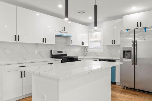 Interior, Kitchen, Marble Walls, Recessed Lighting, Stainless Steel Appliances, Wood Texture Flooring