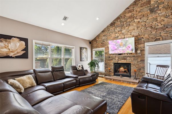 Fireplace, Interior, Living room, Recessed Lighting, Stone Walls, Wood Texture Flooring