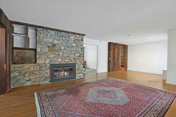 Empty room, Fireplace, Interior, Recessed Lighting, Stone Walls, Wood Texture Flooring