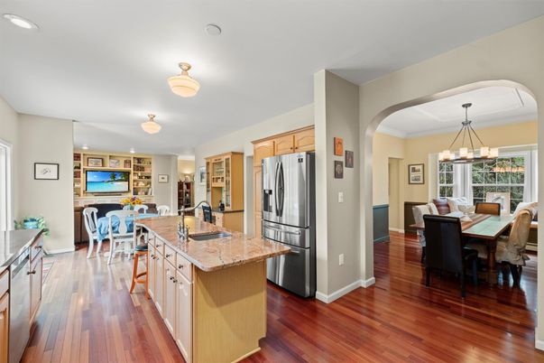 Chandelier, Dining room, Interior, Kitchen, Living room, Pendant Lights, Recessed Lighting, Stainless Steel Appliances, Wood Texture Flooring