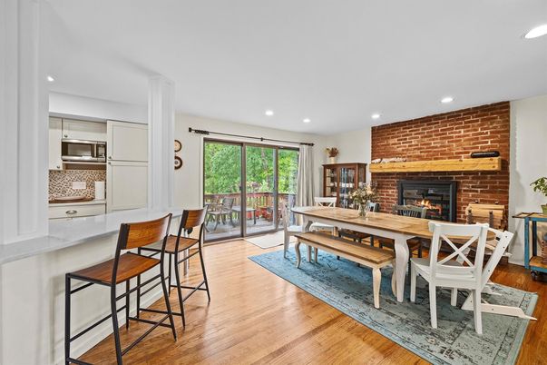 Dining room, Fireplace, Interior, Kitchen, Recessed Lighting, Stainless Steel Appliances, Stone Walls, Wood Texture Flooring