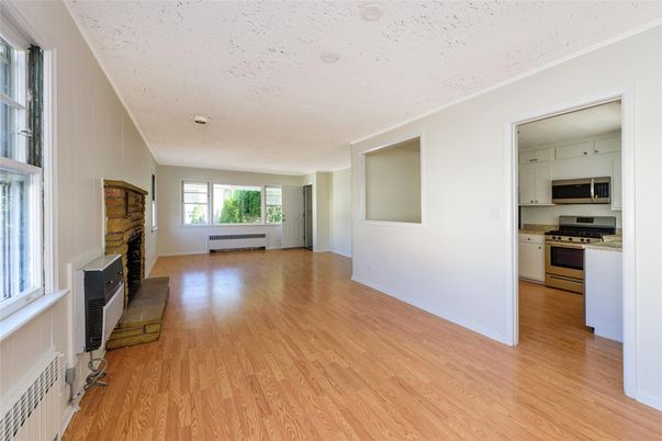 Empty room, Fireplace, Interior, Kitchen, Stainless Steel Appliances, Wood Texture Flooring
