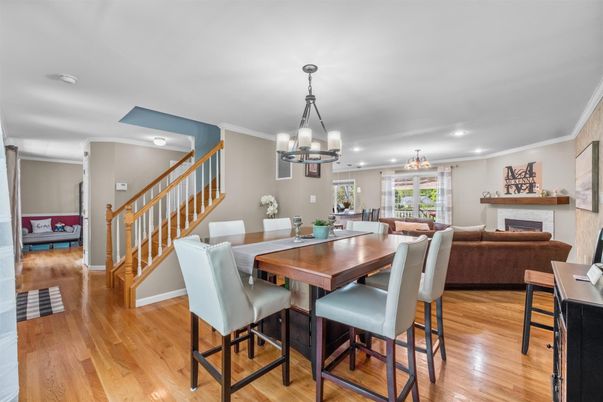 Chandelier, Dining room, Fireplace, Interior, Living room, Pendant Lights, Recessed Lighting, Wood Texture Flooring